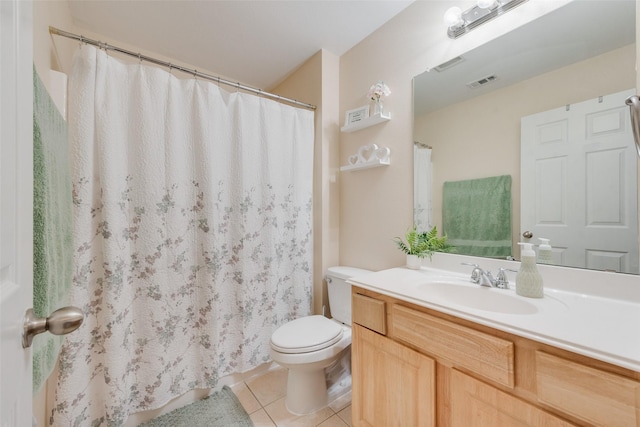 bathroom featuring vanity, tile patterned floors, and toilet