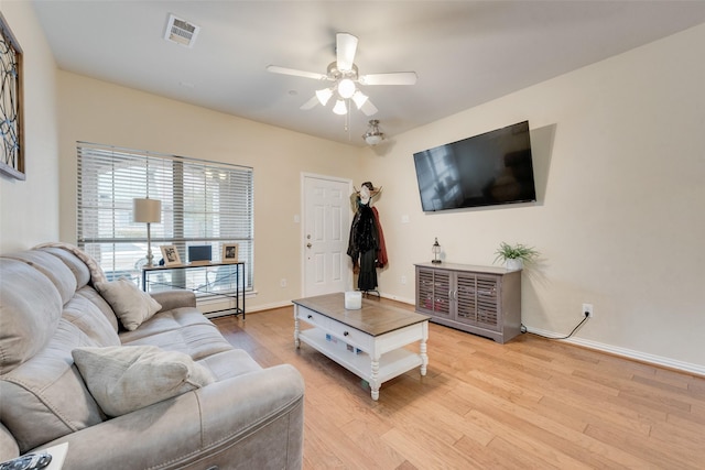 living room with light hardwood / wood-style flooring and ceiling fan