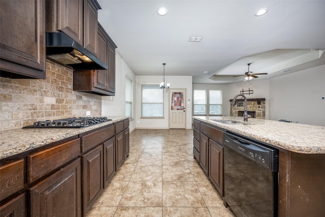 kitchen with sink, decorative backsplash, a kitchen island with sink, exhaust hood, and black appliances