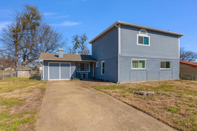 back of property featuring a yard and a garage