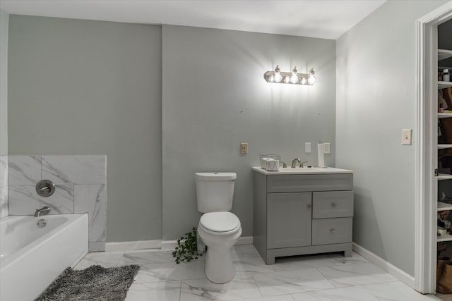 bathroom with vanity, a bathtub, and toilet