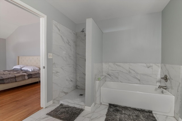 bathroom featuring separate shower and tub