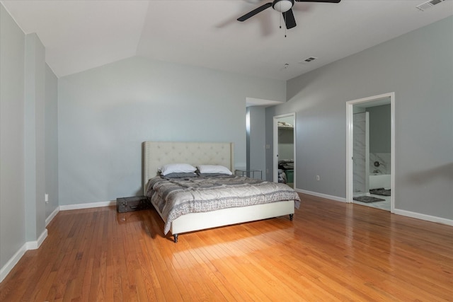 bedroom featuring vaulted ceiling, ceiling fan, ensuite bathroom, and hardwood / wood-style floors