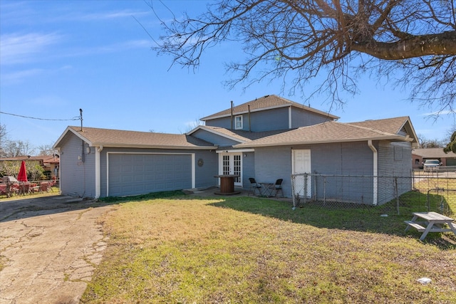 view of front of property featuring a garage and a front yard