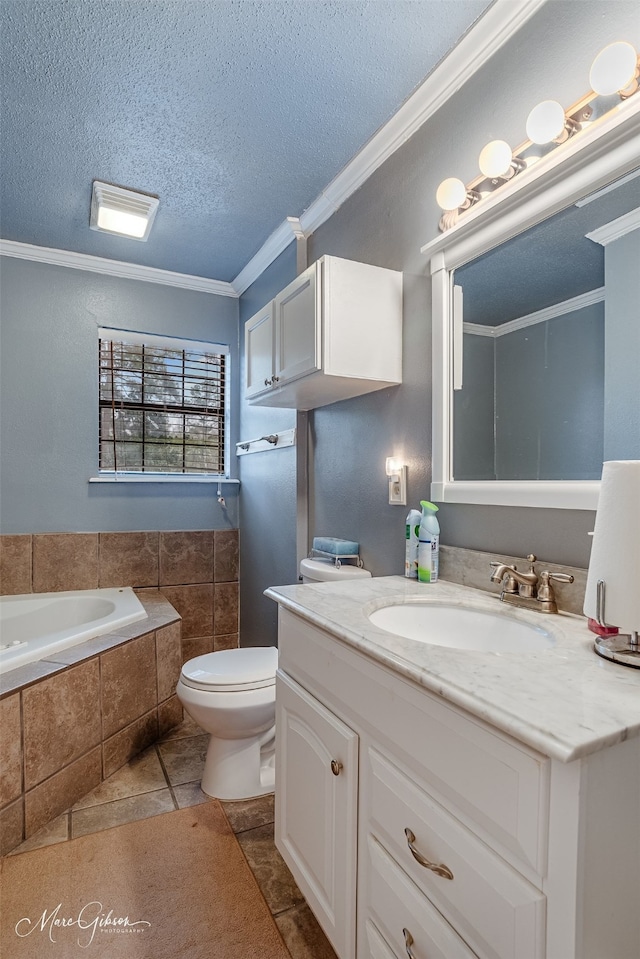 bathroom featuring tiled bath, ornamental molding, vanity, toilet, and a textured ceiling