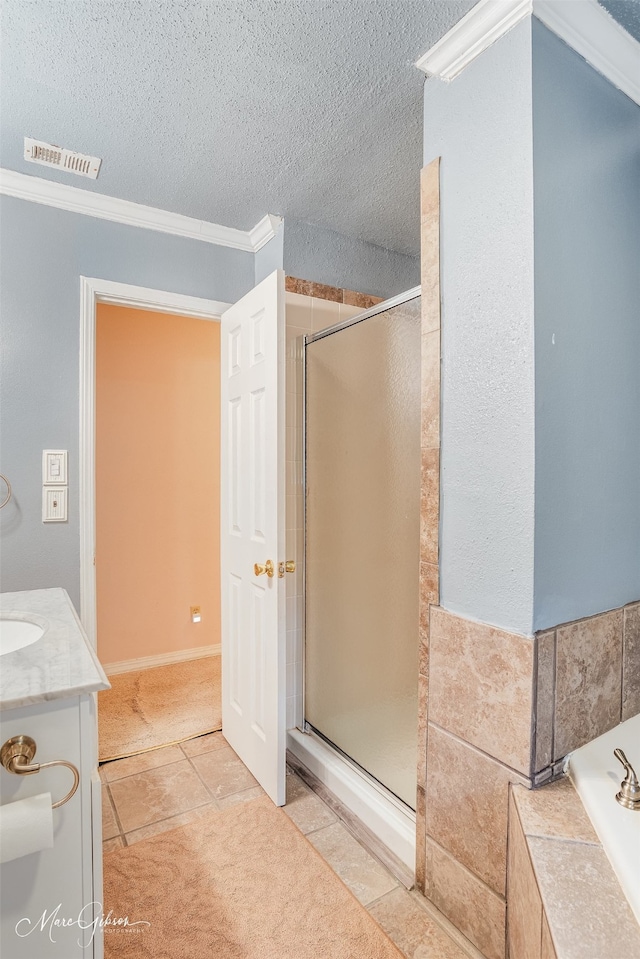 bathroom with ornamental molding, plus walk in shower, tile patterned flooring, and a textured ceiling