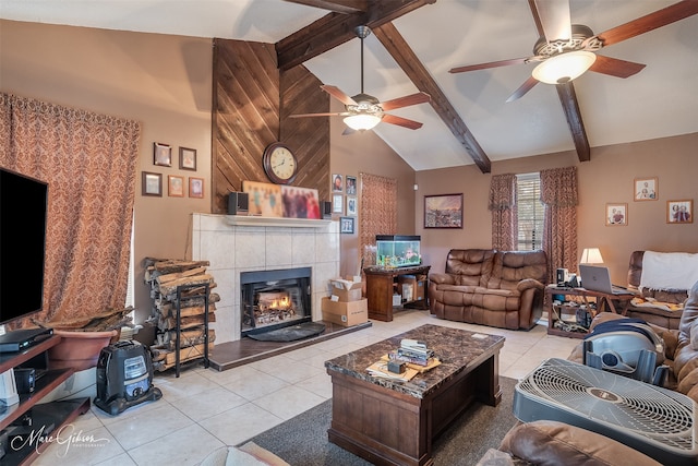 living room with a tiled fireplace, light tile patterned floors, and beam ceiling