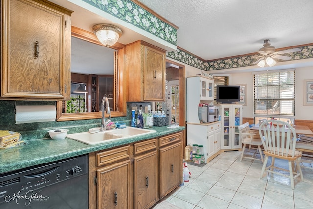 kitchen featuring sink, a textured ceiling, light tile patterned floors, dishwasher, and ceiling fan