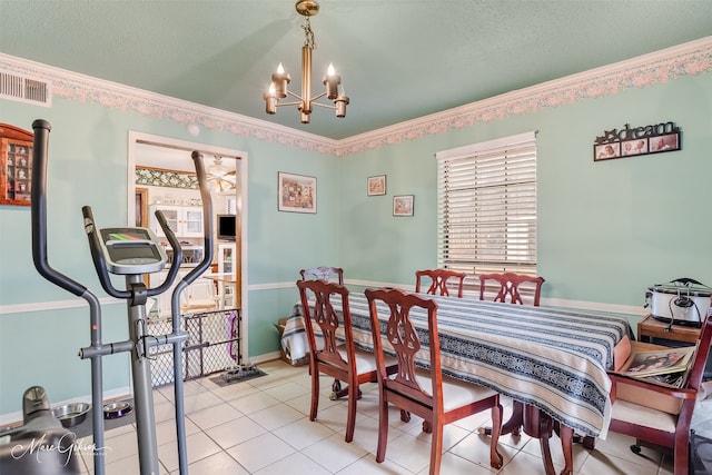 dining space featuring ornamental molding, light tile patterned flooring, a notable chandelier, and a textured ceiling