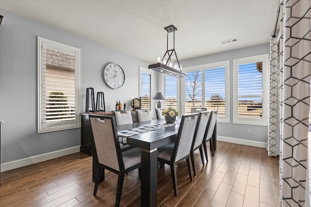 dining space featuring dark hardwood / wood-style flooring and plenty of natural light