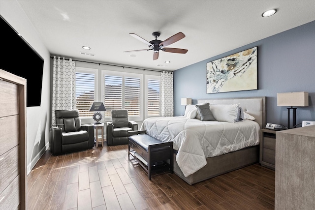 bedroom with dark hardwood / wood-style flooring and ceiling fan