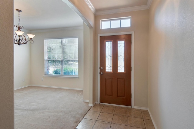 carpeted entryway with crown molding and a notable chandelier