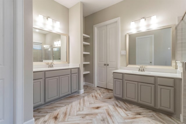 bathroom with vanity, parquet floors, an enclosed shower, and built in features