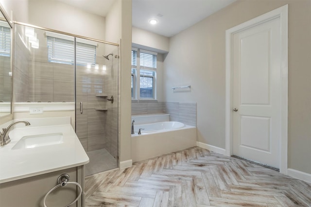 bathroom featuring shower with separate bathtub, parquet floors, and vanity