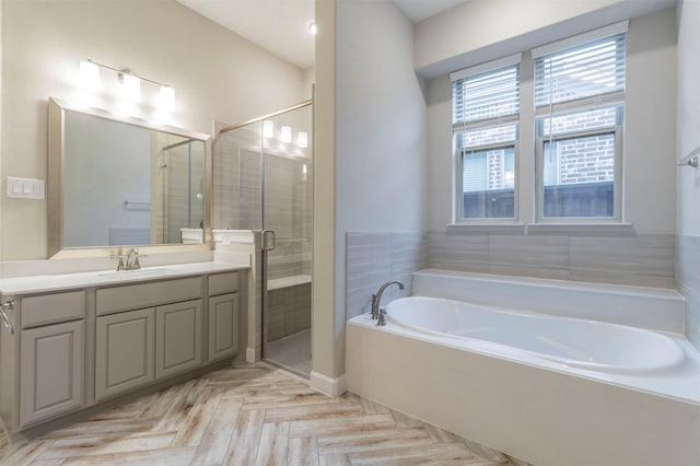 bathroom with vanity, parquet floors, and independent shower and bath