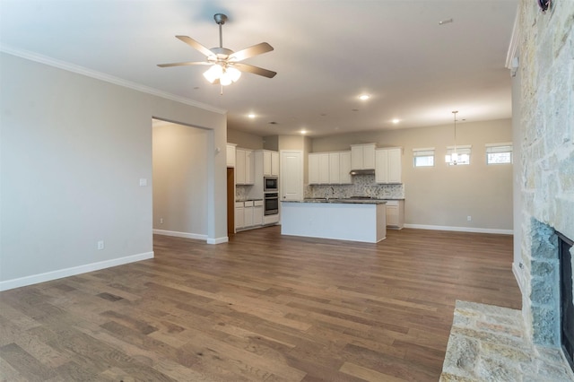 kitchen featuring appliances with stainless steel finishes, a center island, hardwood / wood-style floors, and white cabinets