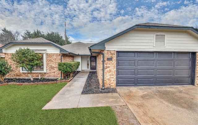 ranch-style house featuring a garage and a front yard