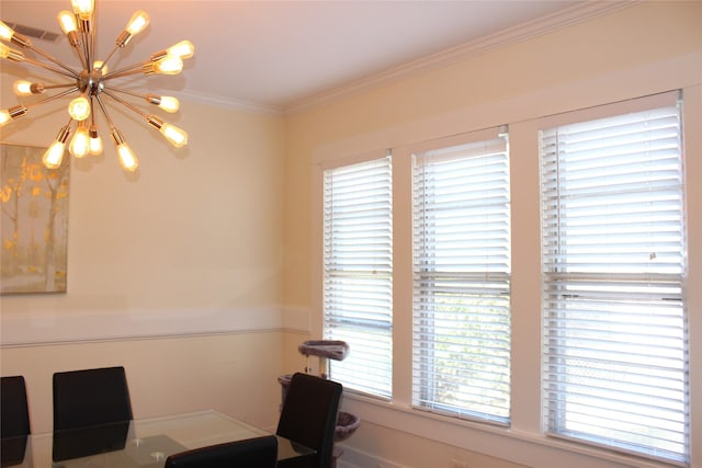 dining space featuring crown molding and a notable chandelier