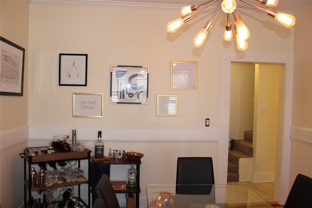 interior space featuring crown molding and a notable chandelier