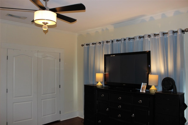 bedroom with ornamental molding, dark hardwood / wood-style floors, and ceiling fan