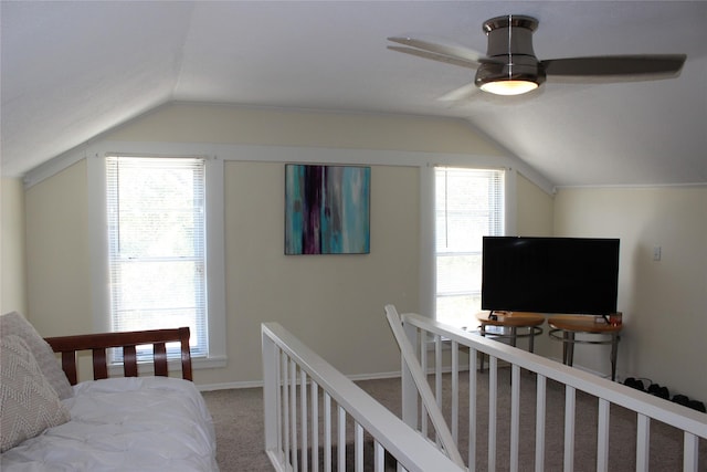 bedroom with ceiling fan, carpet flooring, vaulted ceiling, and multiple windows