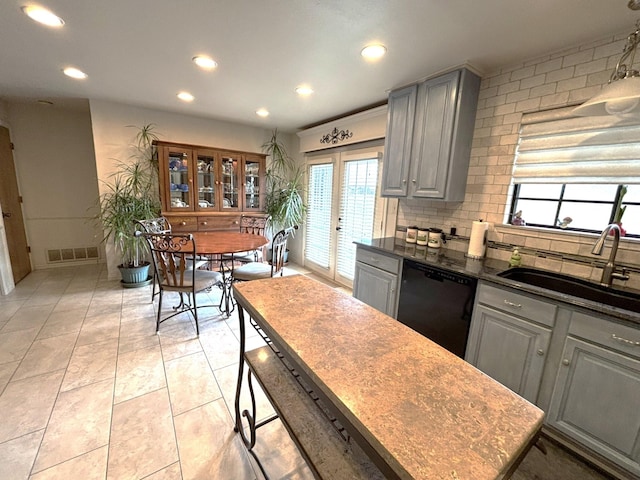 kitchen featuring dishwasher, sink, gray cabinetry, backsplash, and french doors