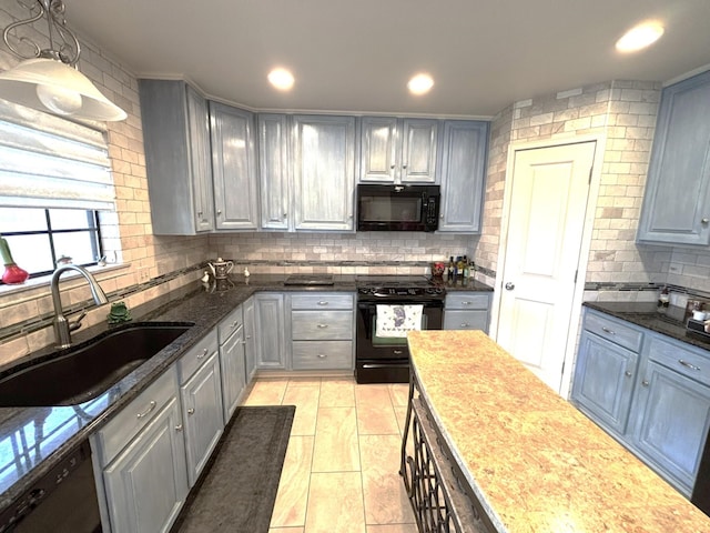 kitchen featuring gray cabinets, sink, pendant lighting, and black appliances