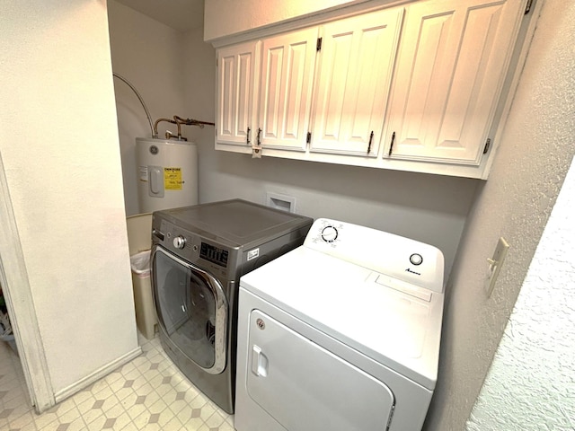 washroom with separate washer and dryer, water heater, and cabinets