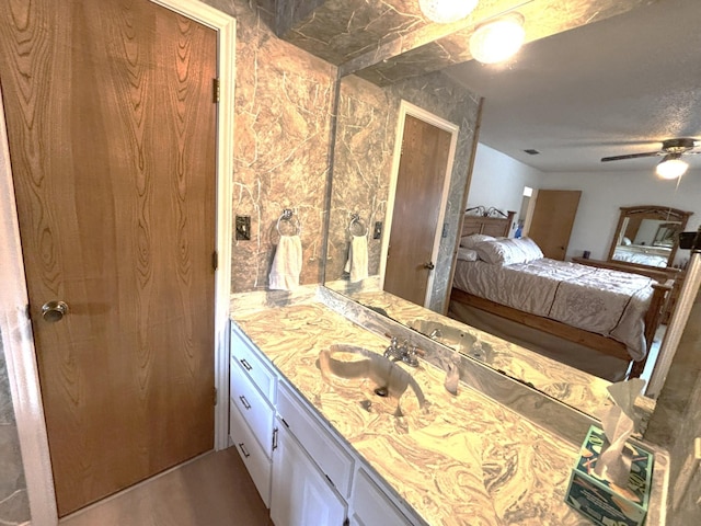 bedroom featuring sink and ceiling fan