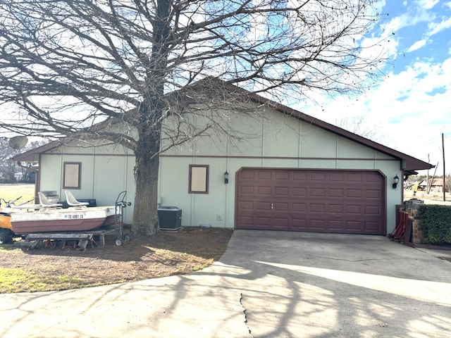 exterior space with a garage and central AC unit