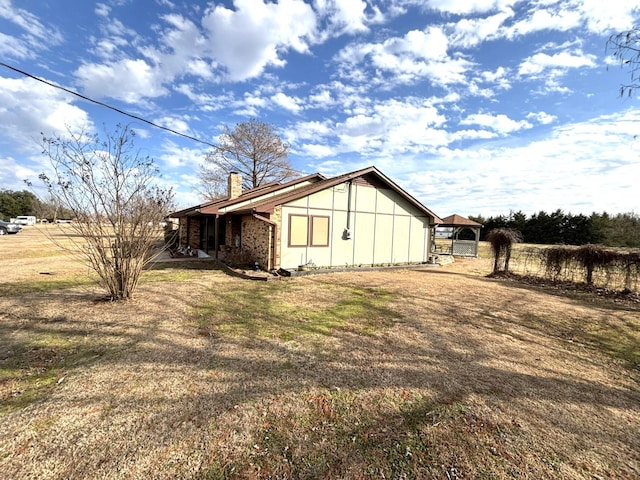 view of side of property with a yard