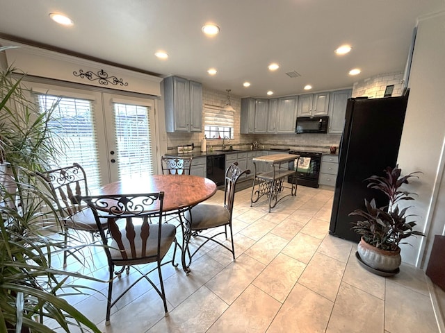 dining area with light tile patterned flooring, sink, ornamental molding, and french doors