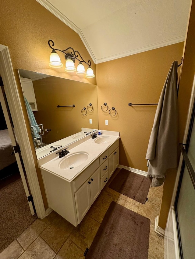 bathroom with lofted ceiling, vanity, and crown molding