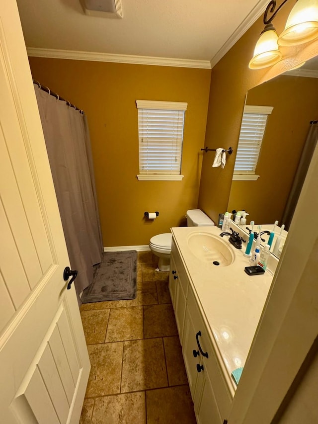 bathroom with ornamental molding, toilet, and vanity