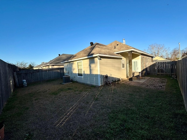 back of property with a patio area and central air condition unit