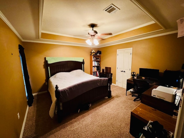 carpeted bedroom with a raised ceiling, ornamental molding, and ceiling fan