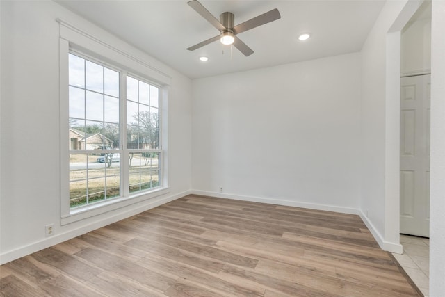 unfurnished room featuring ceiling fan and light hardwood / wood-style flooring