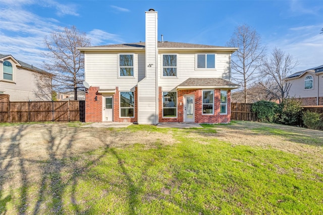 back of house with a lawn