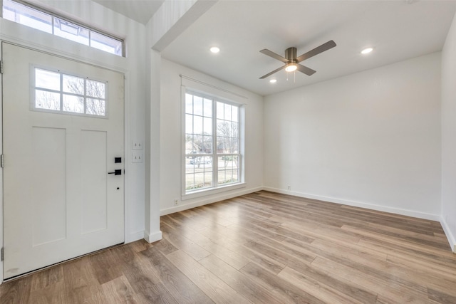 foyer featuring ceiling fan, a healthy amount of sunlight, and light wood-type flooring