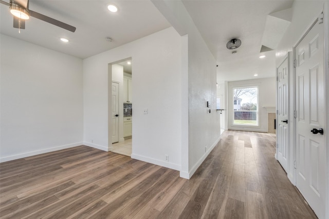 hallway with hardwood / wood-style floors