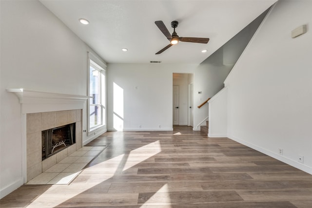 unfurnished living room with a fireplace, light hardwood / wood-style floors, and ceiling fan