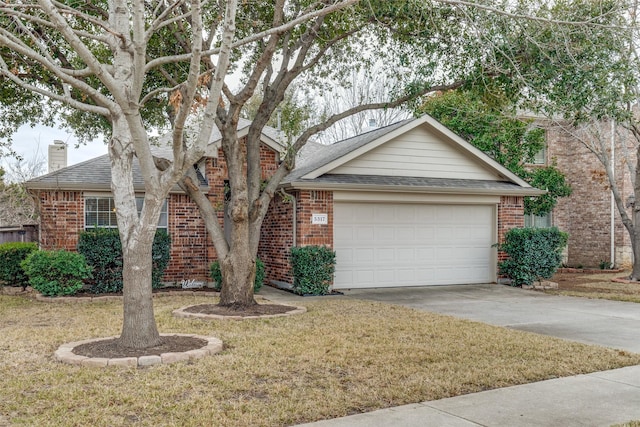 view of front of house with a garage and a front yard