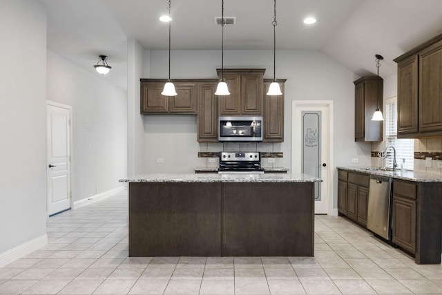 kitchen featuring appliances with stainless steel finishes, visible vents, backsplash, and a sink