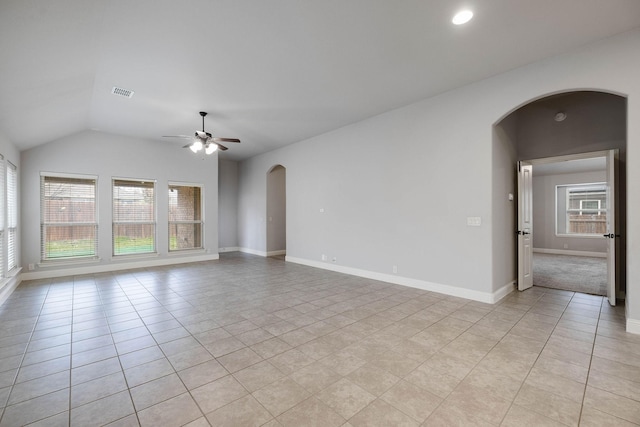 unfurnished room featuring light tile patterned flooring, ceiling fan, plenty of natural light, and vaulted ceiling