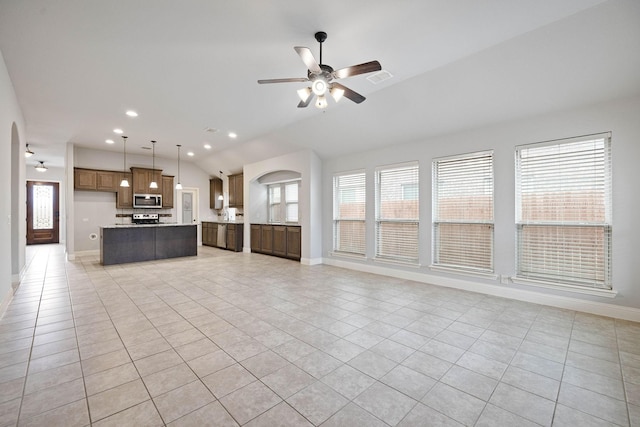 unfurnished living room with light tile patterned flooring, lofted ceiling, and ceiling fan