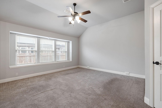 carpeted spare room with lofted ceiling and ceiling fan