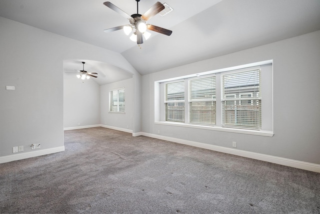 spare room with carpet, ceiling fan, baseboards, visible vents, and lofted ceiling