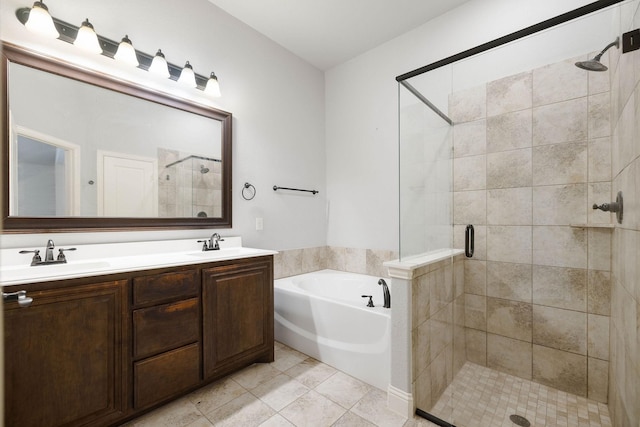 full bathroom featuring a stall shower, double vanity, a sink, and a bath