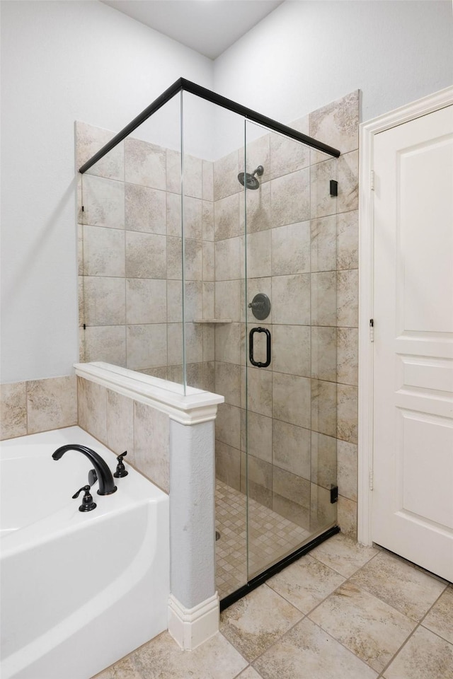bathroom featuring a bath and a stall shower