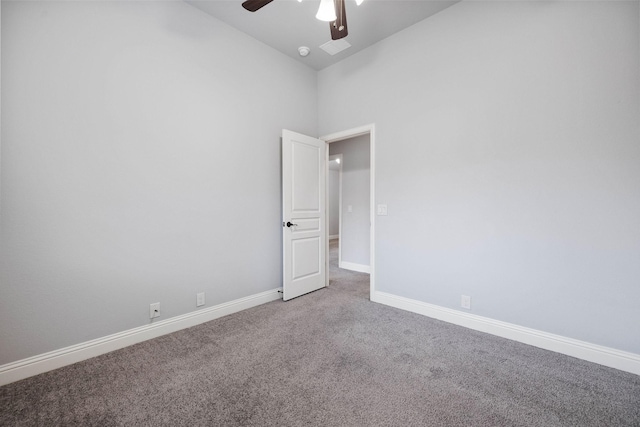 unfurnished room featuring carpet, ceiling fan, high vaulted ceiling, and baseboards